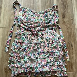 Fun little mini dress. Ruffled with open back. Size M.